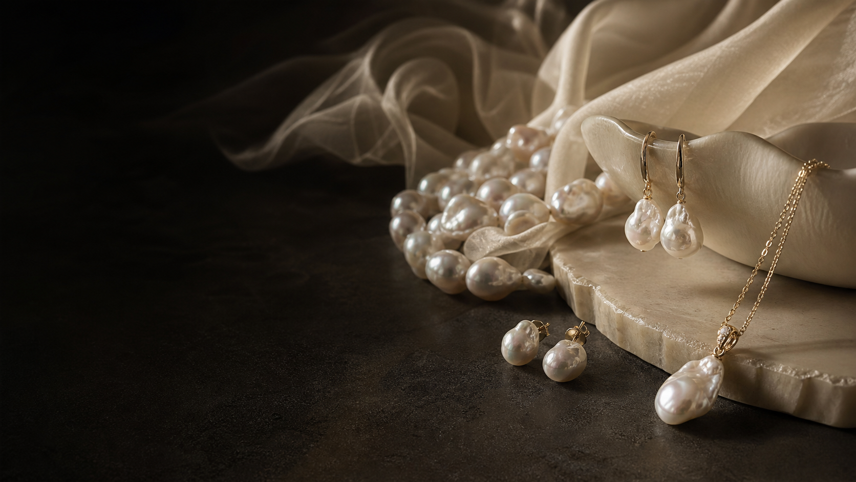 Aurie pearl jewelry arranged on a dark luxury tabletop
